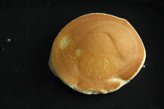 安置好面糊，3个一起煎哈。迅速在面糊周围空的地方，用小勺子淋点清水，然后盖上锅盖，小火单面煎2-3分钟。然后开盖，用刮刀快速翻面，再盖上锅盖煎2-3分钟。