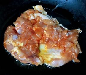 锅中倒入底油加热放入煨制入味的鸡腿肉中火煎起来