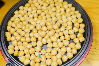 准备一个平底锅，把解冻了的鹰嘴豆放入锅里小火翻炒