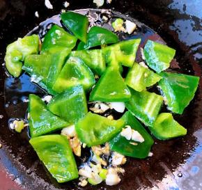 锅中倒入底油加热放入葱姜蒜爆香放入青椒炒至断生