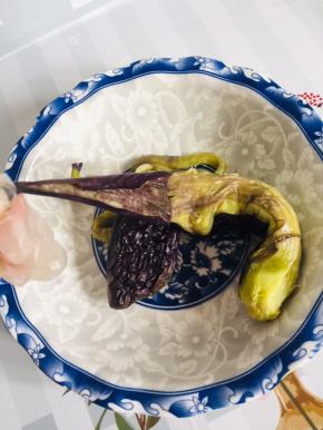 蒸好的茄子放入碗中，撕去茄子皮！