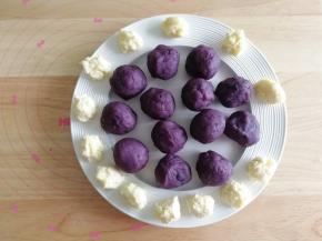 然后将芝士碎分成7克一个，戴上PVC手套（手温会让芝士碎出油，所以建议戴手套，不然手上油油的），搓成团备用！将炒好的紫薯馅料分成35克一个，搓圆备用。