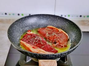 再放入腌制好的牛排，中小火煎，这里分享一下煎牛排不同熟度的大约时间。（一分熟：烹饪1分钟“极生”。三分熟：烹饪2分钟“中生”，五分熟：烹饪3分钟“稍熟”，七分熟：烹饪4分钟“中熟”，九分熟：烹饪5分钟“全熟”）仅供参考。