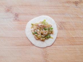 取一个锅贴皮，放上肉馅。