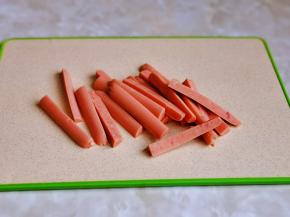 火腿切条，一根火腿肠小一切二，再切四。