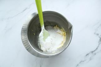 软化到用刮刀可以轻易抹开的黄油，将纯糖粉筛入（可以用普通糖粉，纯糖粉容易结块，所以需要过筛），用刮刀稍微混合，看不见糖粉即可，防止打发时候糖粉飞溅。