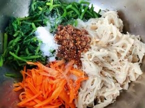 茼蒿、金针菇、胡萝卜、自制蒜蓉辣椒油、糖、醋、盐、味精放入容器中