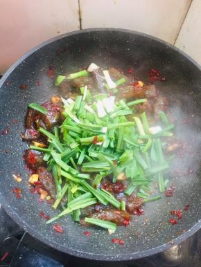 放入蒜苗翻炒均匀！