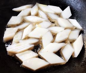 锅中倒入底油加热放入焖子中火煎起来