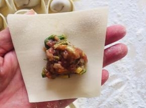 取一张饺子皮，放入适量的肉馅儿！