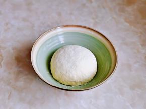 分次加入水，揉成面团，盖上湿布进行发酵。