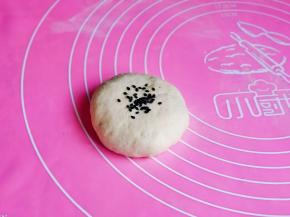 如包子手法包起来，收口捏紧朝下揉圆，再放上黑芝麻。