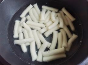 年糕泡凉水中化开，锅中加入一大碗水烧开，放入年糕煮至变胖后捞出，泡入凉水中备用。