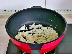 起油锅，加入切好的金针翻炒。