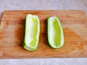 西葫芦洗干净后从中间切开，挖掉瓜瓤。