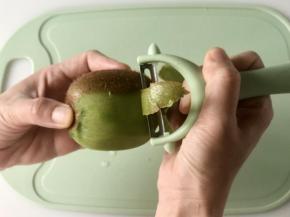 用削皮刀把奇异果的表皮削掉；