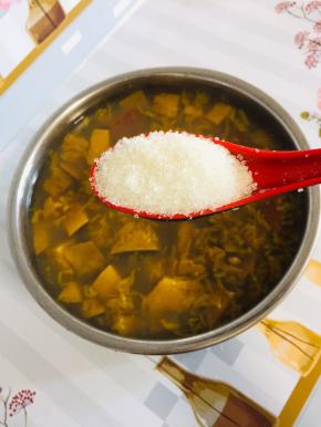 待电压力锅气压阀落下来，打开盖子，放入4勺白糖搅拌至融化l