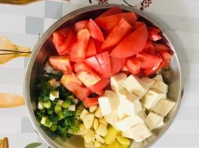 西红柿洗净切成片，嫩豆腐切成小块，生姜切成片，蒜瓣对半切开，葱切成葱花备用！