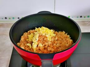 再加入煎好的鸡蛋，虾仁，小火翻炒。