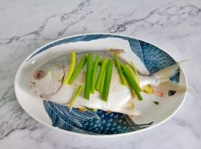 生姜切丝垫一点在盘底，鱼腹塞些姜丝去腥，在鱼的表面抹上盐腌制10分钟让其更加地入味。