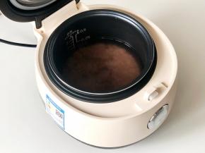 把十谷米和大米洗净，放入电饭煲，加入适量清水，水面高出米面1指节（约2厘米），选择“杂粮饭”程序。