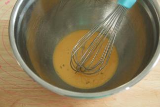 蛋黄25克放入干净盆中，倒入朗姆酒，用蛋抽搅打均匀。