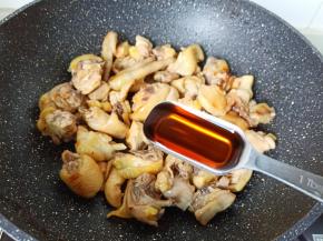 待鸡块里面的油脂渗出，加入料酒两勺。