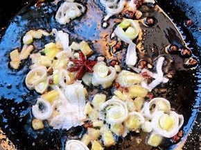 锅中倒入底油加热放入花椒和八角炸香再放入葱姜蒜爆香