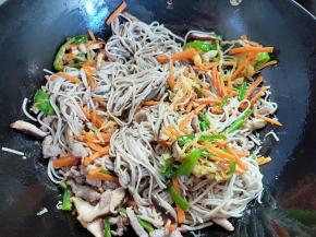 倒入肉丝和配菜，翻炒均匀。