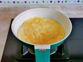 不粘锅中刷油，倒入蛋液，小火煎。