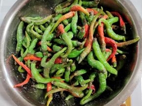 加入适量的盐拌匀！让盐均匀的裹在尖椒上！（盐不要 太多，10斤尖椒3两盐的比例即可！）