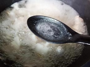 将五花肉表面的浮沫撇去，焯水后的五花肉记得清洗一下，控干水份备用。