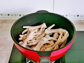 再加入焯水的鸡爪，翻炒两分钟。