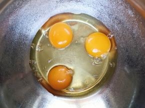 鸡蛋磕入打蛋盆里。 