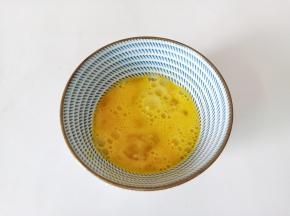 用筷子将鸡蛋液打散。