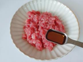 把猪肉泥放入碗里，加料酒一勺。