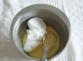 取1/3蛋白霜入蛋黄糊中，左手配合逆时针转盆，右手用蛋抽从2点钟方向切入，从盆底划到7点钟方向翻起到盆中心，重复动作，初步混匀。