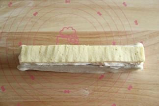 再挤上一层奶油，将草莓完全覆盖，然后放上一条蛋糕胚（哪一面朝上都可以）