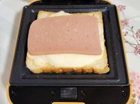 放入一片切好的火腿肠，有条件的可以换成培根！