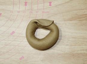 然后将细的一头转圈到宽宽的另一头面片上。