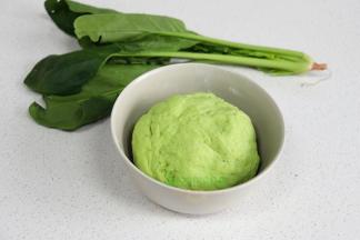 新鲜的菠菜清洗干净，切段放入榨汁机，把菠菜榨汁，然后取280克菠菜汁，倒入500克饺子面粉里，搅拌均匀。揉搓光滑的面团，盖上一块湿布，静放10分钟。