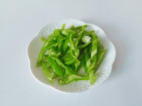 青椒去籽对半切开，切成细丝。