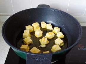 锅里放适量的油，把豆腐块一个个码入，开中小火慢慢煎。