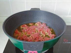 锅里放适量的食用油，油温五成热放入牛肉丝爆炒。