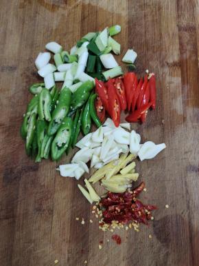 青红辣椒切成小块，蒜瓣切成片，生姜切成丝，干辣椒切成段备用！