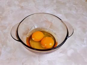 鸡蛋磕入碗中。