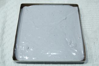 拌匀的面糊从20CM左右高度，倒入垫好油布的28*28烤盘中，晃平或者用刮板刮平，提起从高处振2下振出大气泡。