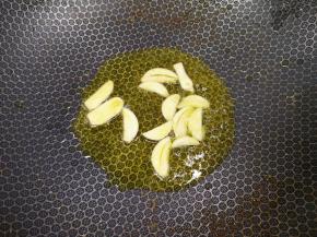 锅里重新倒油烧热，下入蒜片炒香。