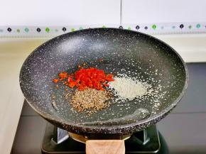 锅中留底油，加入孜然，白芝麻，辣椒碎。