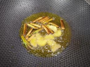 中火炸至葱段变成焦黄色，下入生姜片炒香。